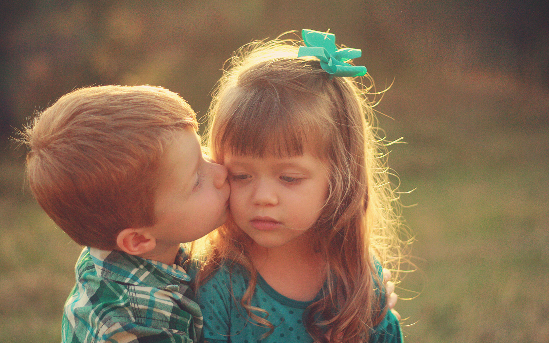 cute baby girl and boy kissing