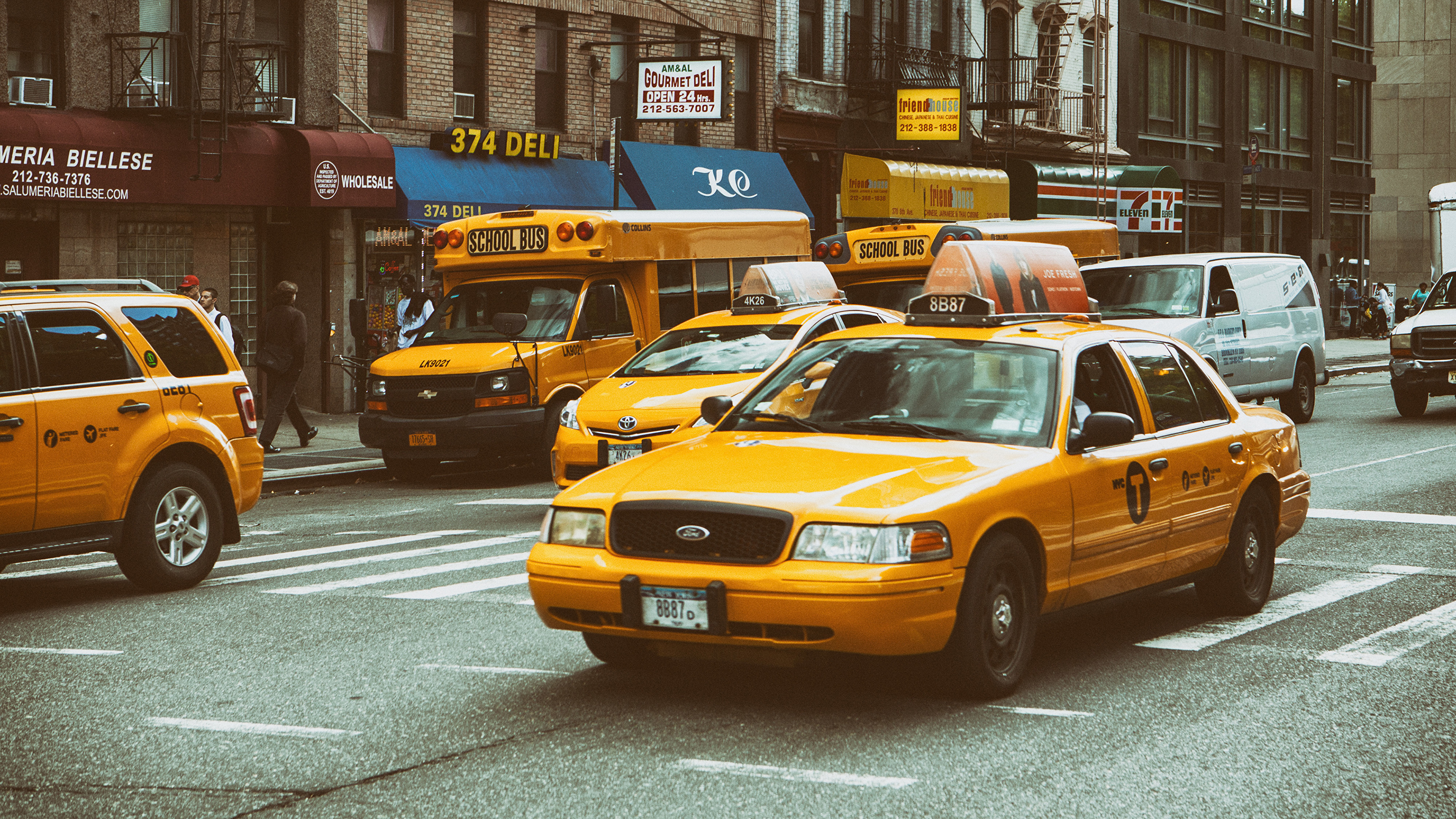taxi cabs stop at a red light at a busy intersection in downtown ...