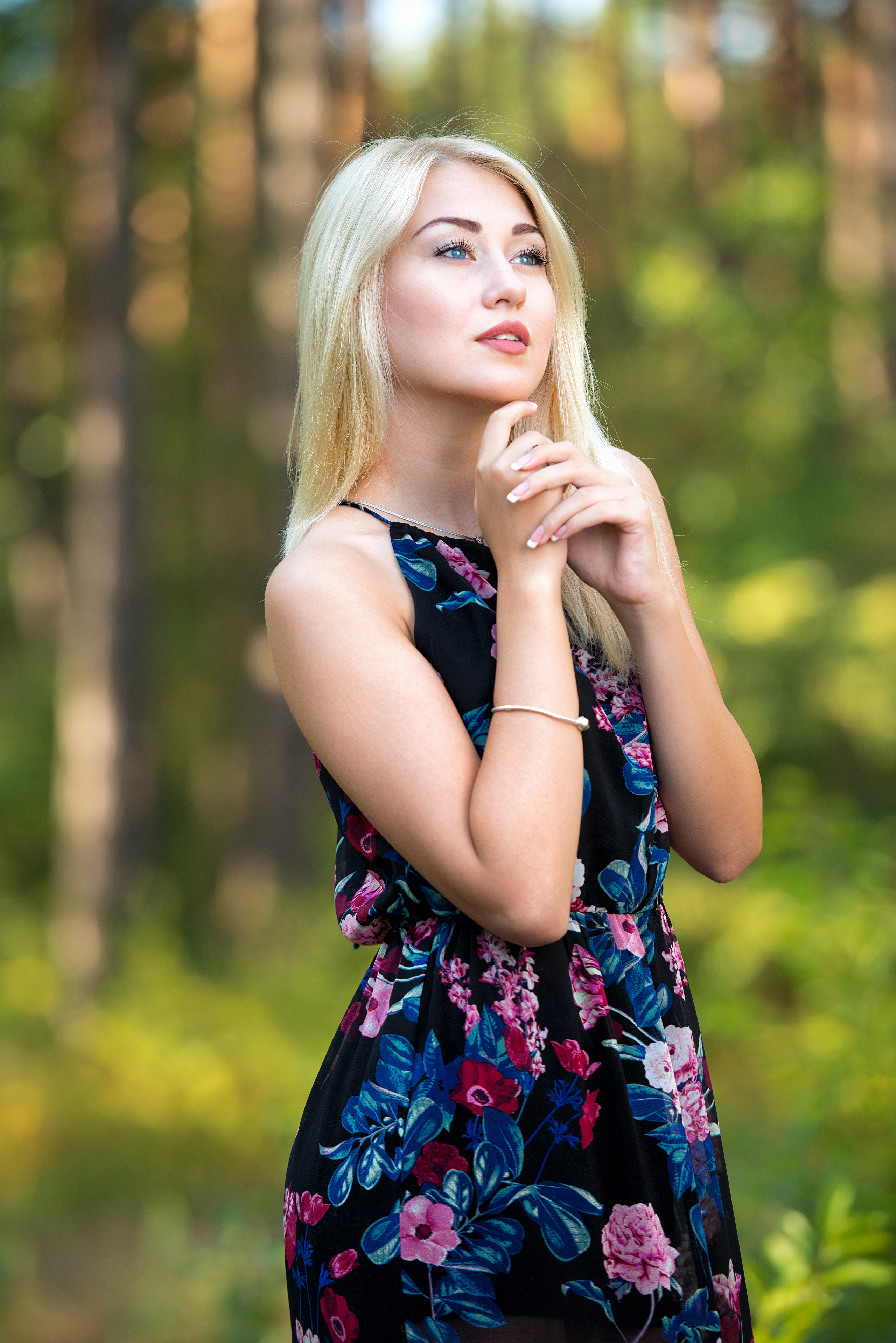 Beautiful girl in dress poses on rock in nature Stock Photo - Alamy