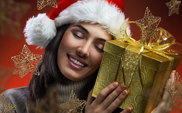 Images Christmas Cosmetics Brunette girl Winter hat Little stars Present Smile Face female