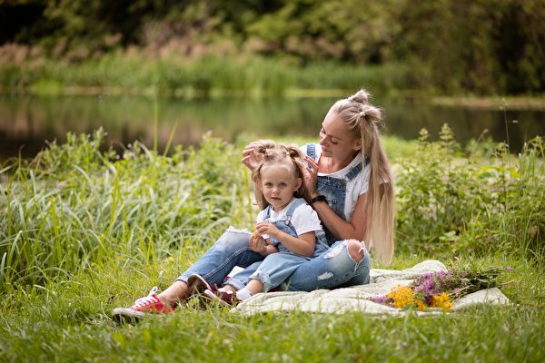 Photo Mother Grass Two Blonde girl Little girls Sitting Hands Legs Jeans young woman